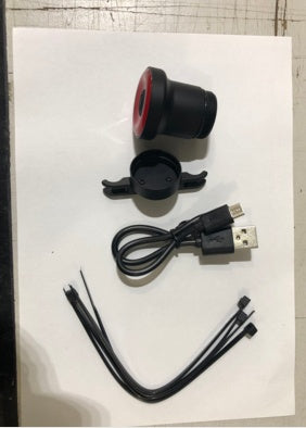 ENFITNIX Xlite100 Rear Bicycle Light, USB cable, and connectors on a white surface