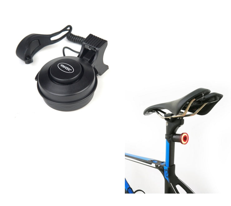 Black electric bike bell with mounting bracket and bicycle with a rear light on a white background