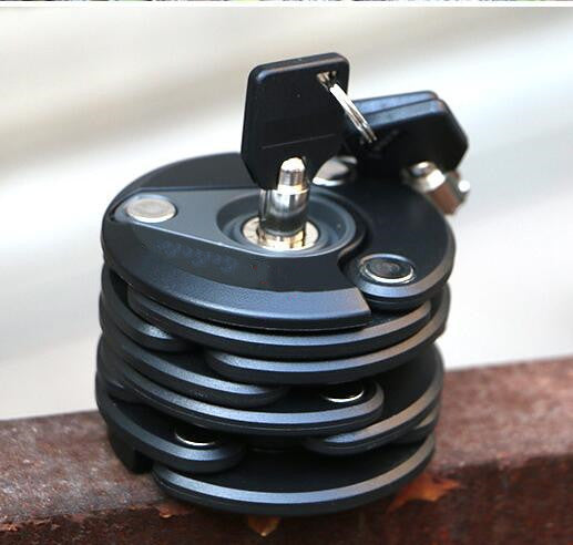 Close-up of aExtendable Bicycle Lock and a black housing on a blurred background