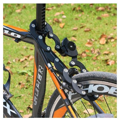 Close-up of a bicycle with a black seat, Extendable Bicycle Lock and orange frame on a grassy background.