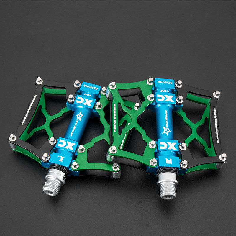 Pair of green and blue Flat Aluminium Bicycle Pedals on a black background