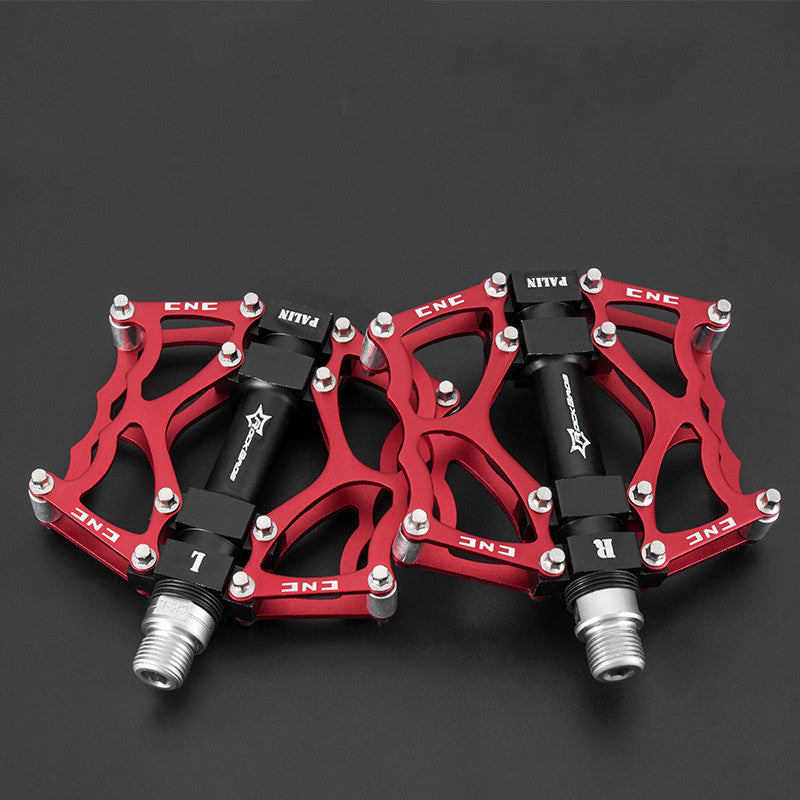 Red and black Flat Aluminium Bicycle Pedals on a dark background
