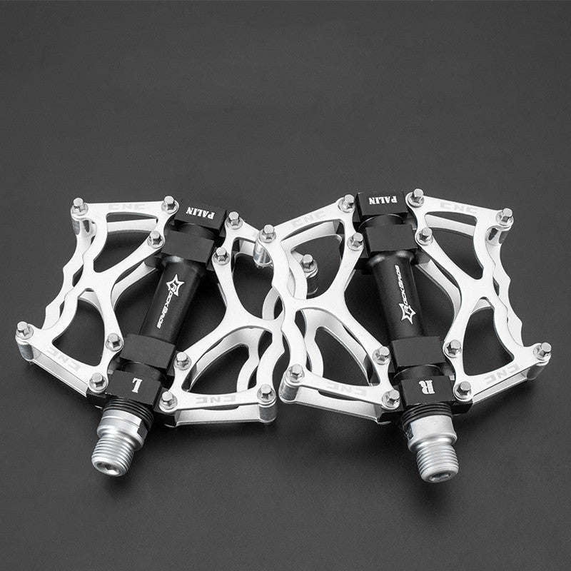 Pair of Flat Aluminium Bicycle Pedals on a dark background