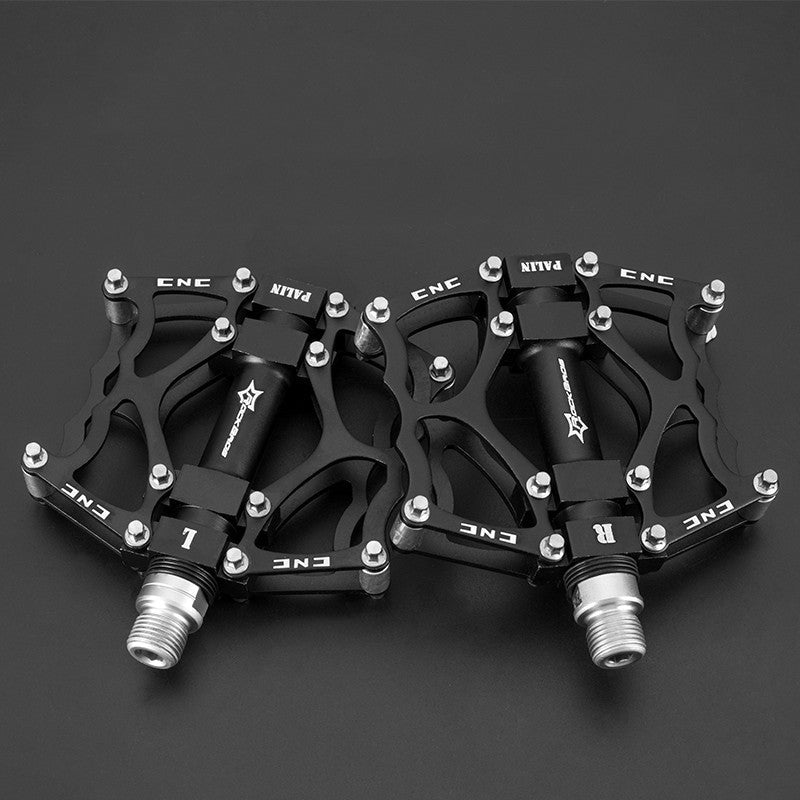 Pair of black Flat Aluminium Bicycle Pedals with metallic ends on a dark background
