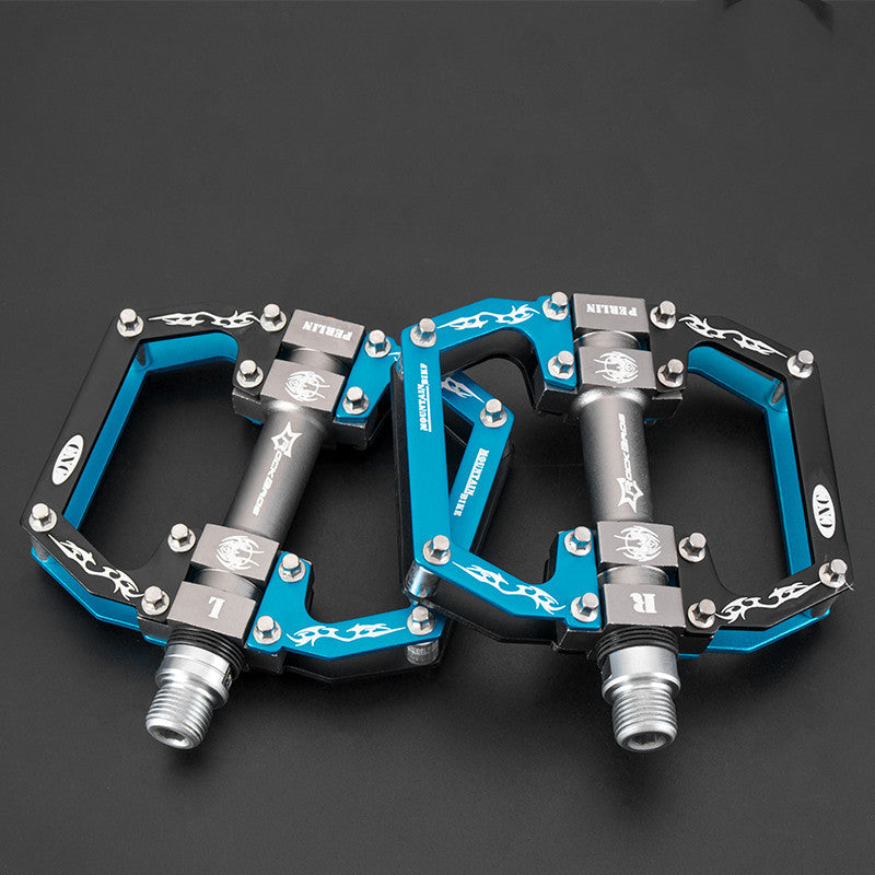Pair of blue and black Flat Aluminium Bicycle Pedals on a dark background