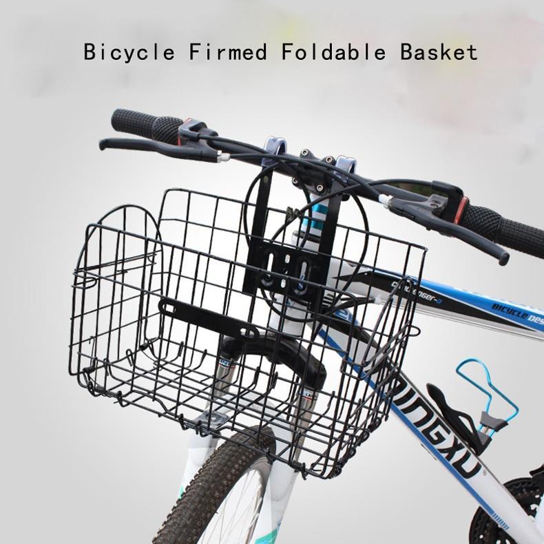 Bicycle with a black foldable basket attached to the handlebars on a light gray background.