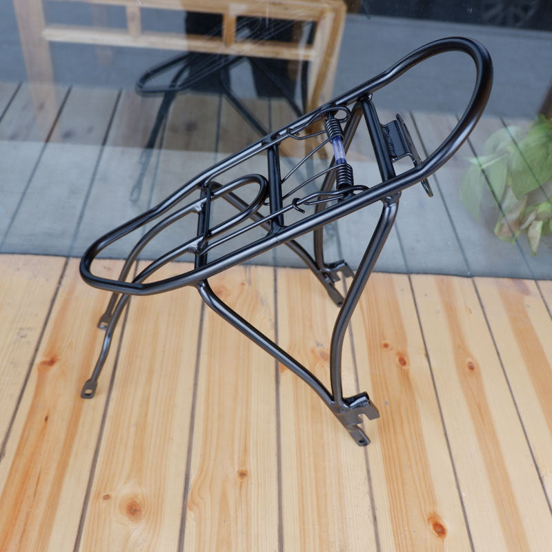 Black bicycle rear rack on a wooden deck