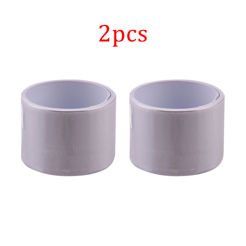 Two white reflective cycling leg bands on a white background