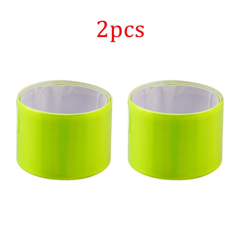 Two relective leg bands with a white center on a white background