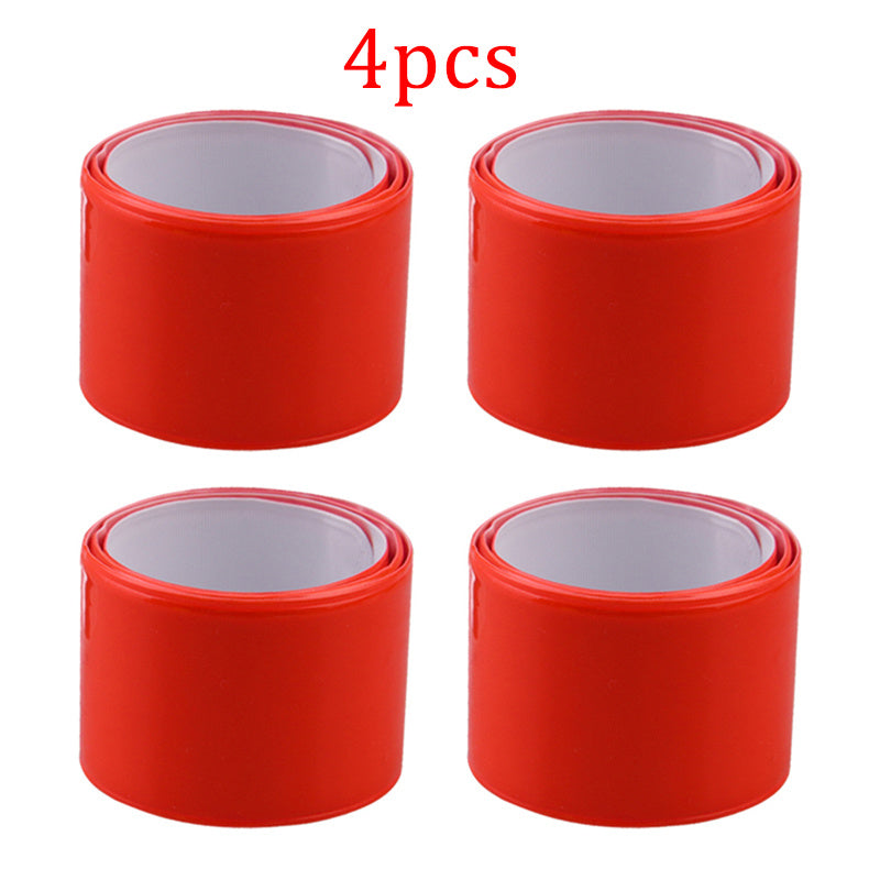 Four red relective cycling arm bands on a white background.