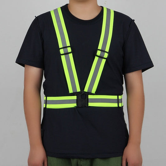Person wearing a black t-shirt with a high-visibility safety vest on a gray background