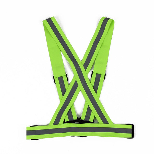 Green safety vest with reflective stripes on a white background