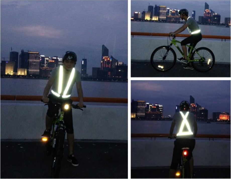 Person riding a bike at night with q reflective cycling safety vest against a cityscape background