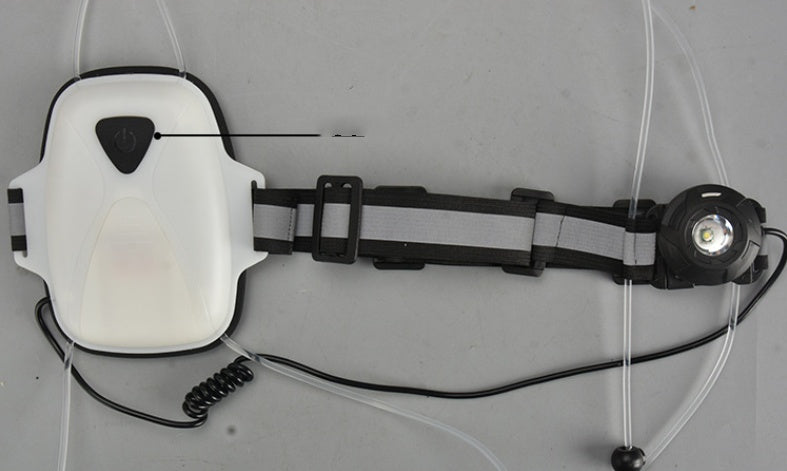 Close-up of hi-viz cycling vest with integrated LED light on a gray background