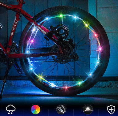Bicycle wheel with colorful LED lights on a dark background