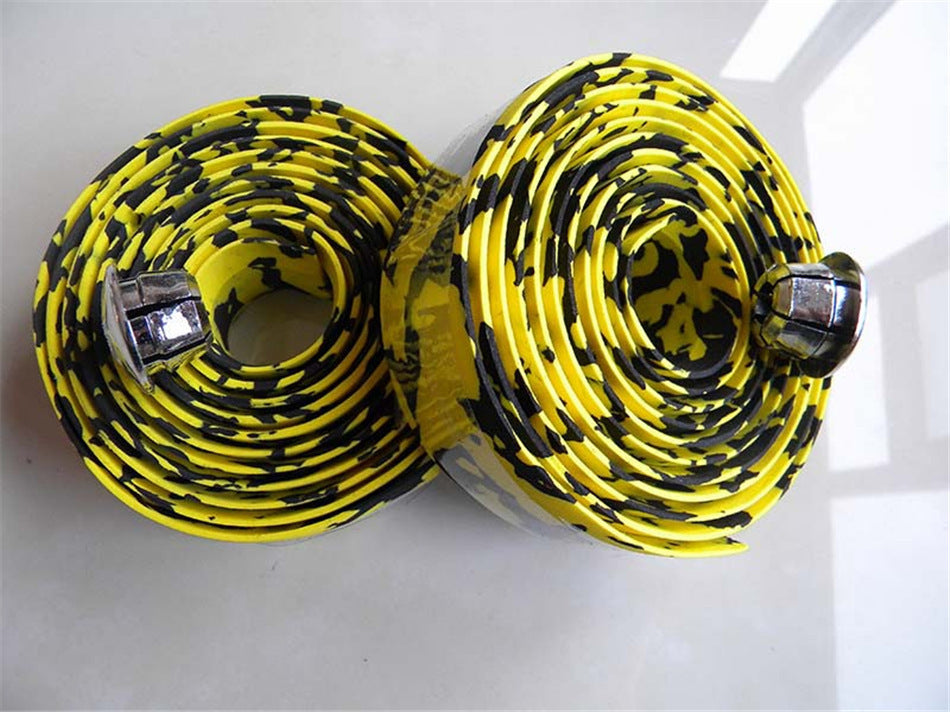 Two rolls of yellow and blackLightweight, Non-slip Bicycle Handlebar Tape with bar plugs on a white background