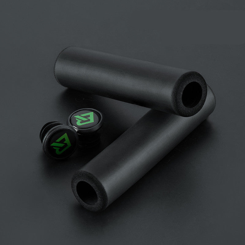 Black MTB handlebar grips with green logo on a dark background