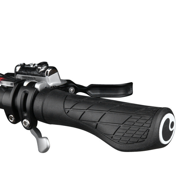 Close-up of a black bicycle handlebar grip with brake lever on a white background