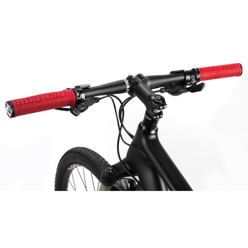 Close-up of a bicycle handlebar with red grips on a white background