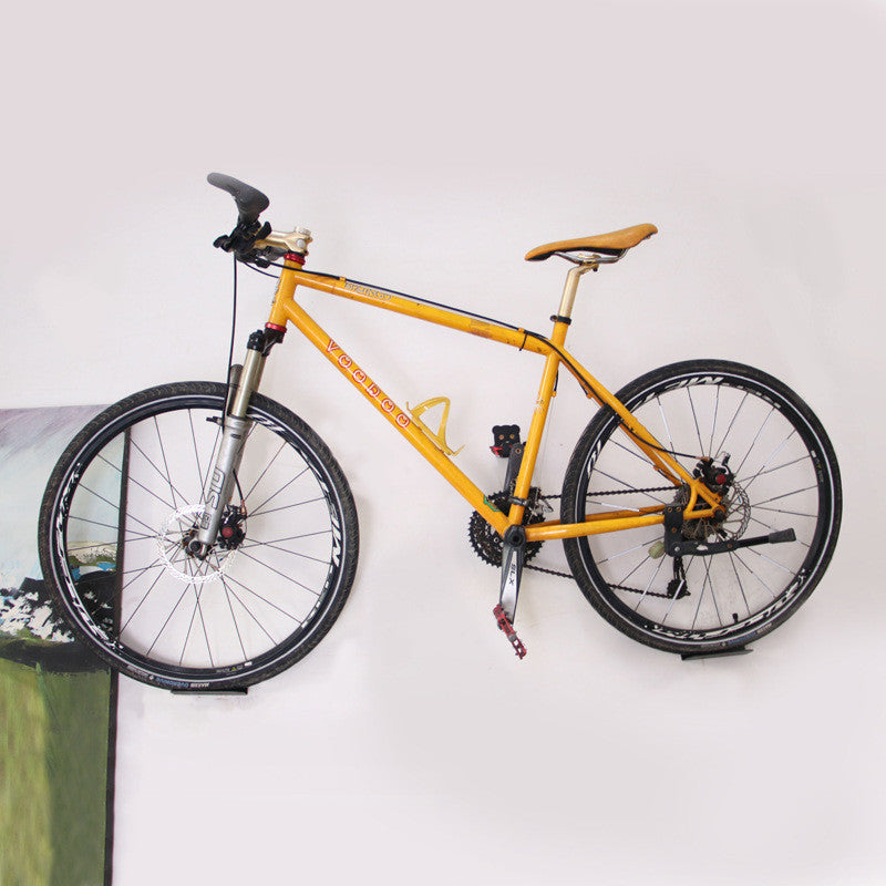 Yellow bicycle mounted on a white wall
