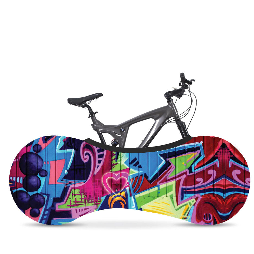 Bicycle with a colorful graffiti-patterned dust cover on a white background