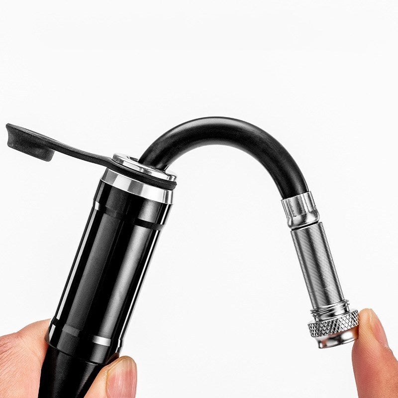 Black Mini High-Pressure Aluminium Bicycle Pump valve connector held by a hand on a white background