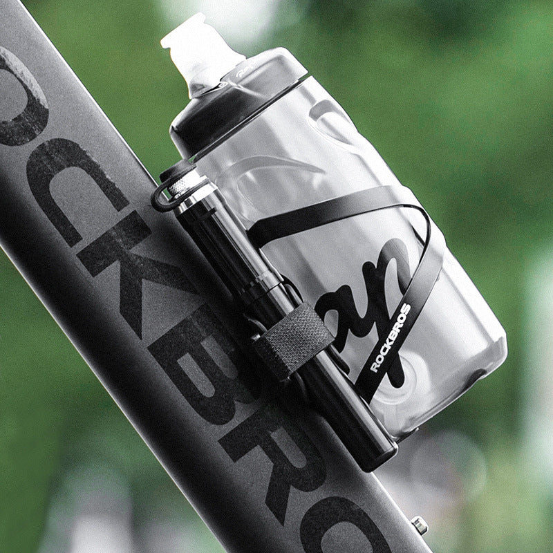 RockBros bicycle with a water bottle holder and Mini High-Pressure Aluminium Bicycle Pump with a blurred green background