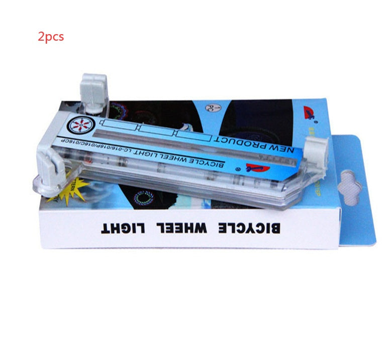 Bicycle LED wheel light packaging with two lights on a white background
