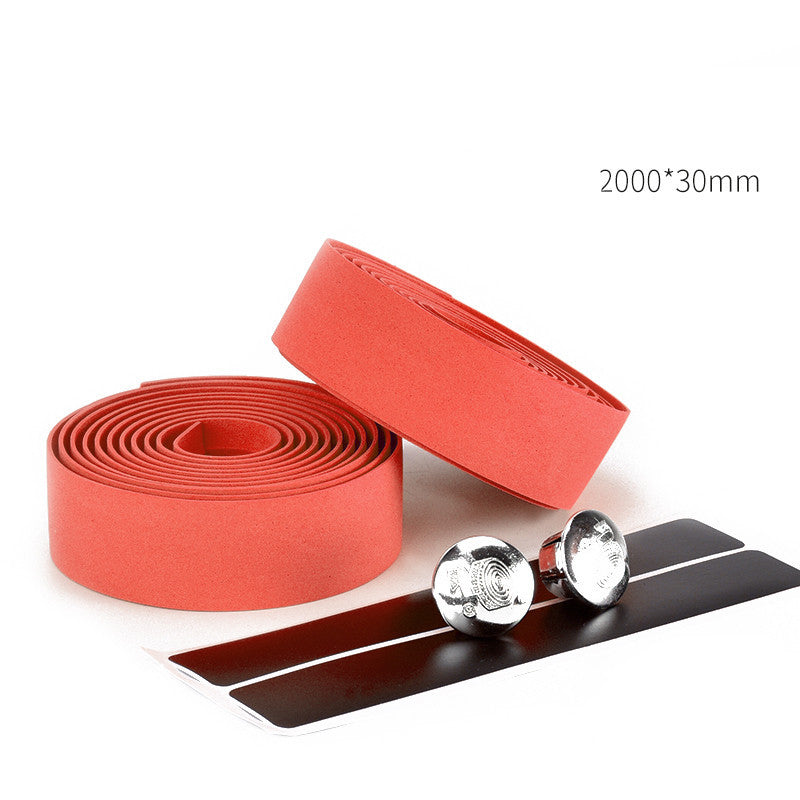 Red bicycle handlebar tape with bar caps on a white background