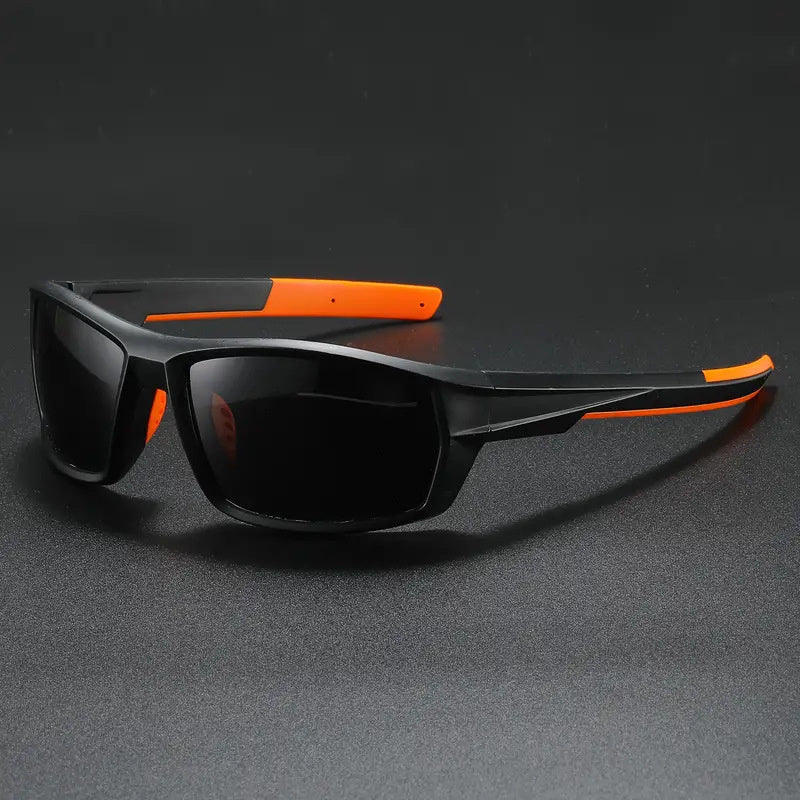 Black and orange polarized cycling sunglasses on a dark gray background