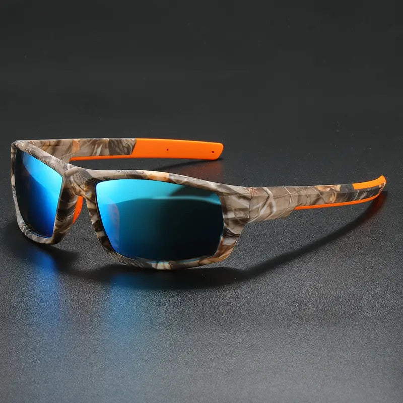 Camouflage pattern polarized cycling sunglasses with orange accents on a dark surface