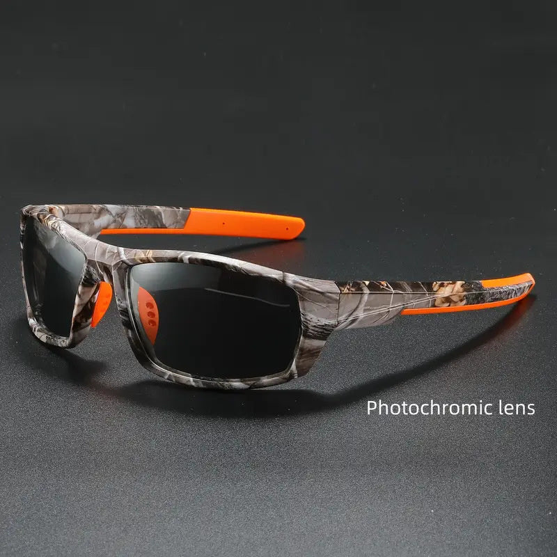 Polarized cycling sunglasses with camouflage frame and orange accents on a dark background