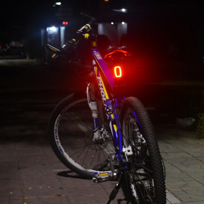 Bicycle with a red light on a dark street