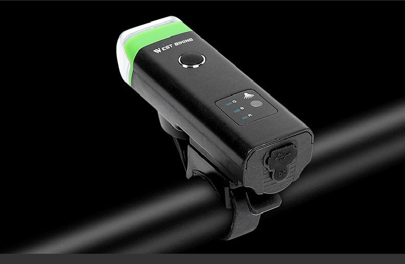 Black bike light with green accent on a black background