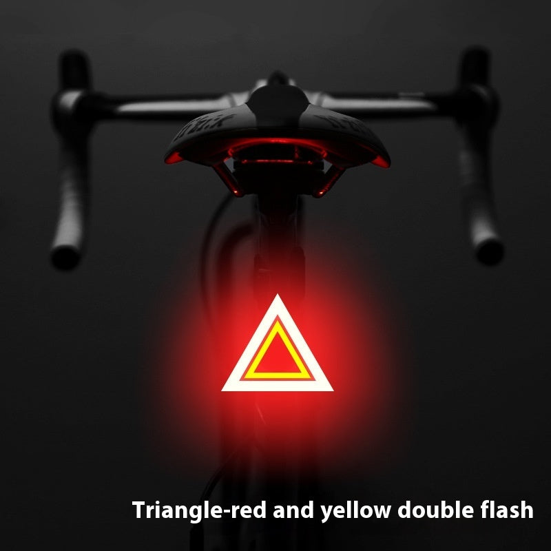 Rechargeable USB Bicycle Rear Light with red and yellow triangle warning symbol on a dark background