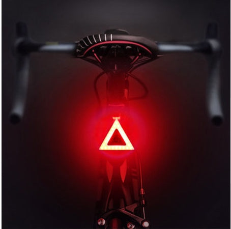 Rechargeable USB Bicycle Rear Light with red glow on a dark background