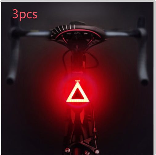 Rechargeable USB Bicycle Rear Light with red warning triangle on a dark background, labeled '3pcs'.