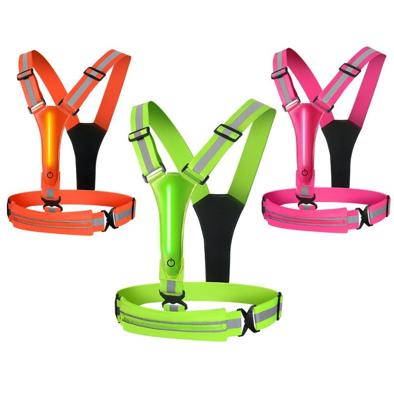 Set of four reflective safety harnesses with built-in LED lights in orange, green, and pink on a white background