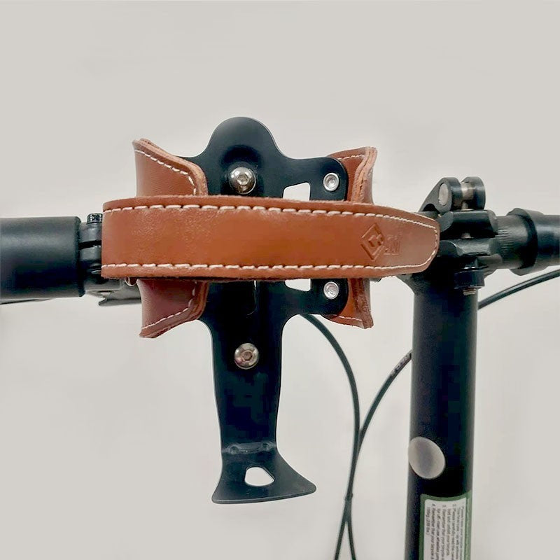 Brown Retro Cowhide Bicycle Bottle Holder/Cage on a bicycle with a gray background