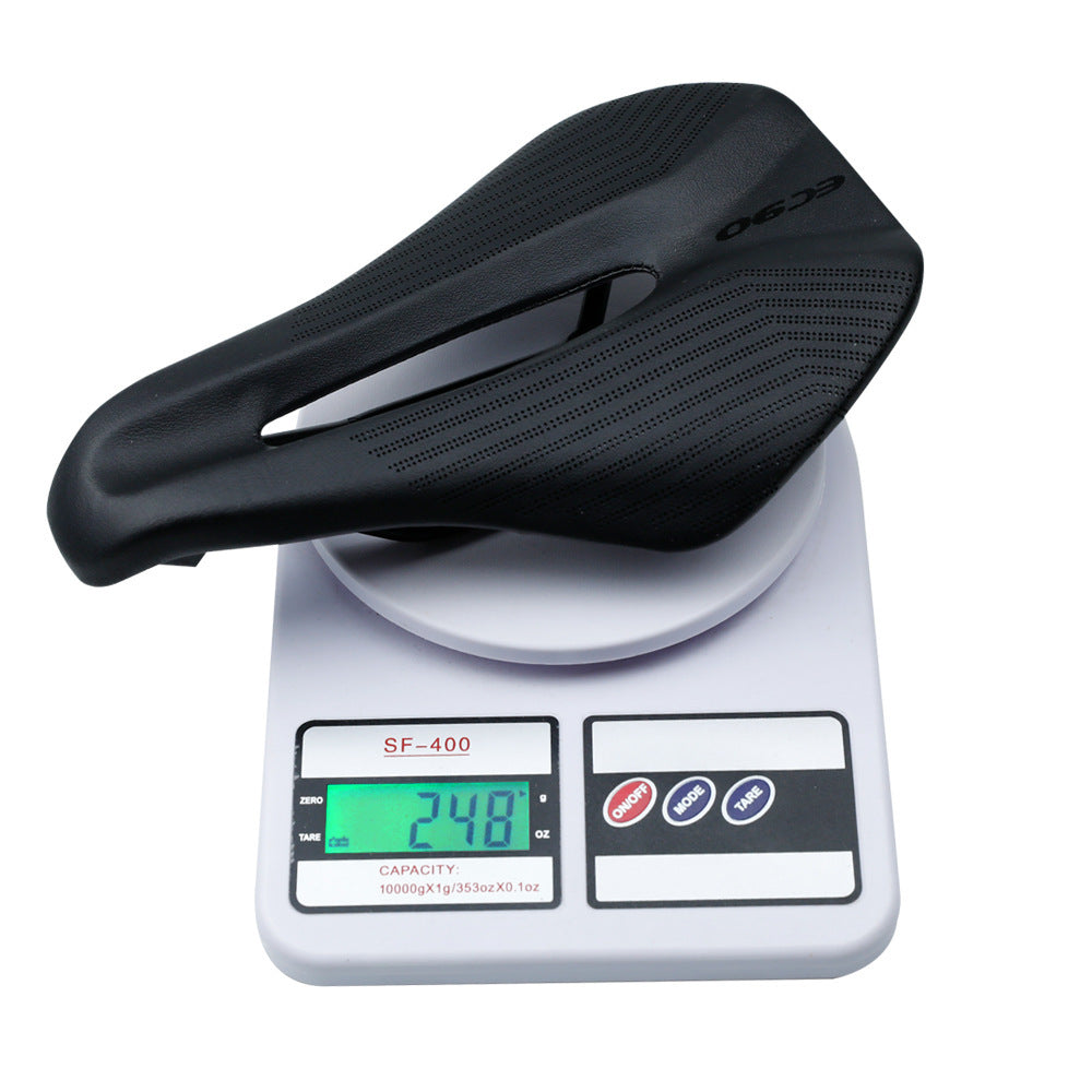 Black bicycle saddle being weighed on a digital scale with a white background
