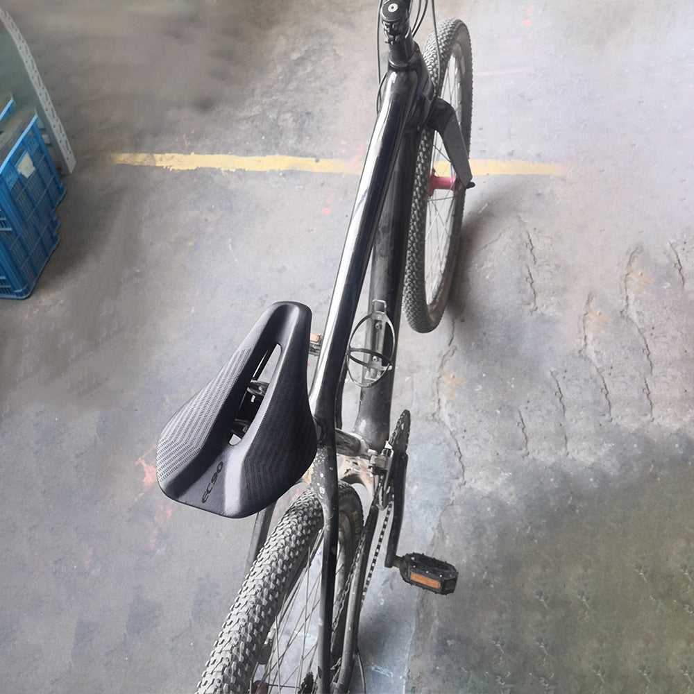 Black bicycle with Short Nose Lightweight Bicycle Saddle in an indoor setting