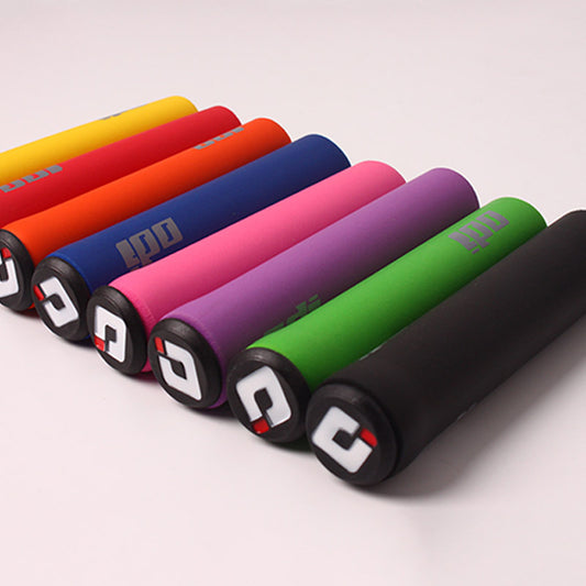 Colorful silicone bicycle handlebar grips arranged in a row on a light gray background