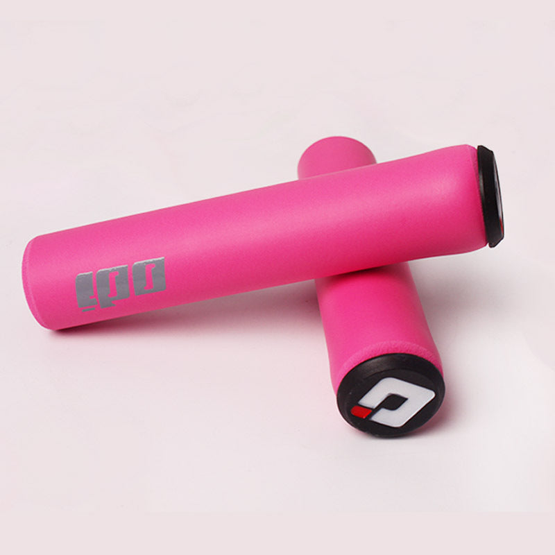 Pink silicone bicycle handlebar grips with visible branding on a light pink background