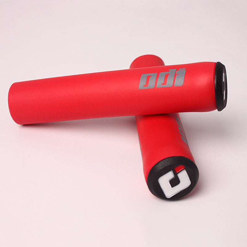 Red silicone bicycle handlebar grips with visible branding on a light background