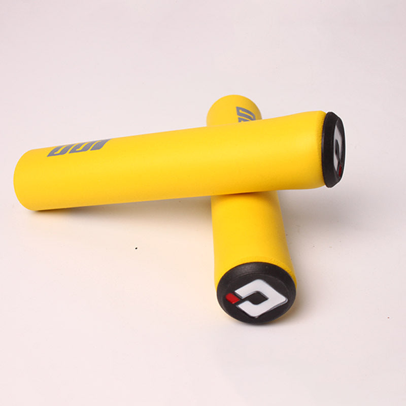 Yellow silicone bicycle handlebar grips with black ends on a white background