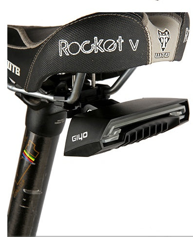 Close-up of a bicycle seat with 'Rocket V' branding and a Smart Rear Bicycle Light on a white background