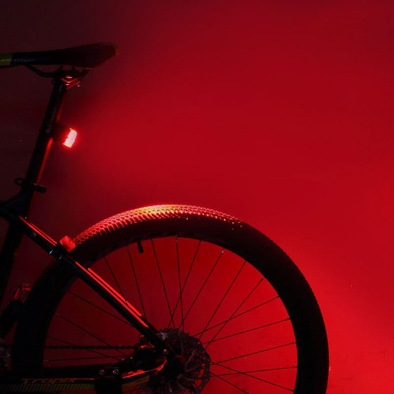 Bicycle with a red light on a red background
