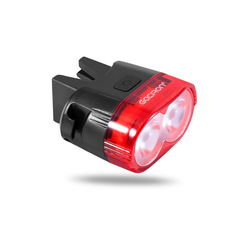 Red bicycle light with black casing on a white background