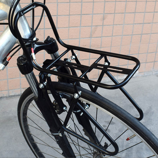 Black bicycle rack attached to a bike with a tiled wall background