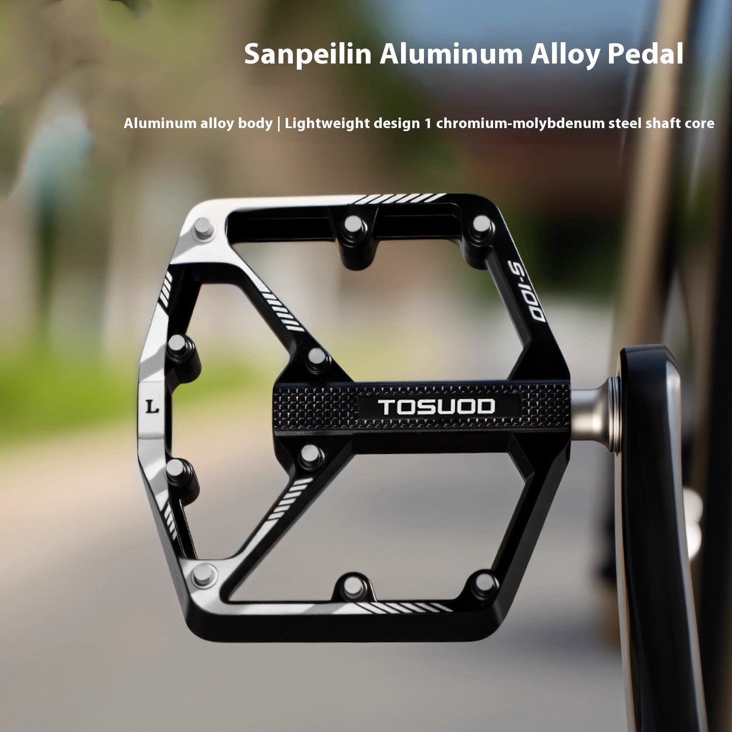 Black and silver CNC aluminium alloy bicycle pedal with 'TOSUOD' branding on a blurred background